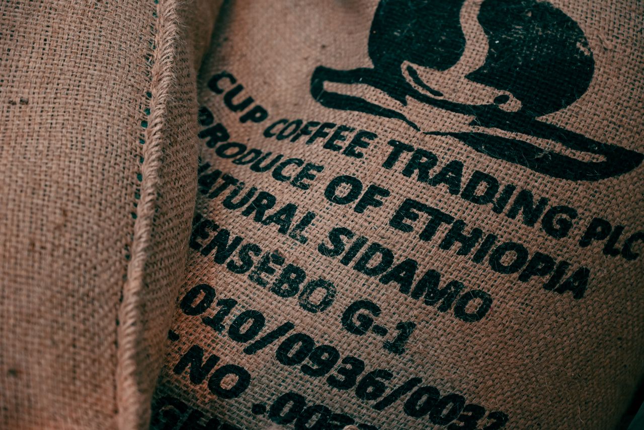 journey-01 Close-up of a burlap sack displaying the Ethiopian coffee logo and wording, highlighting its texture.